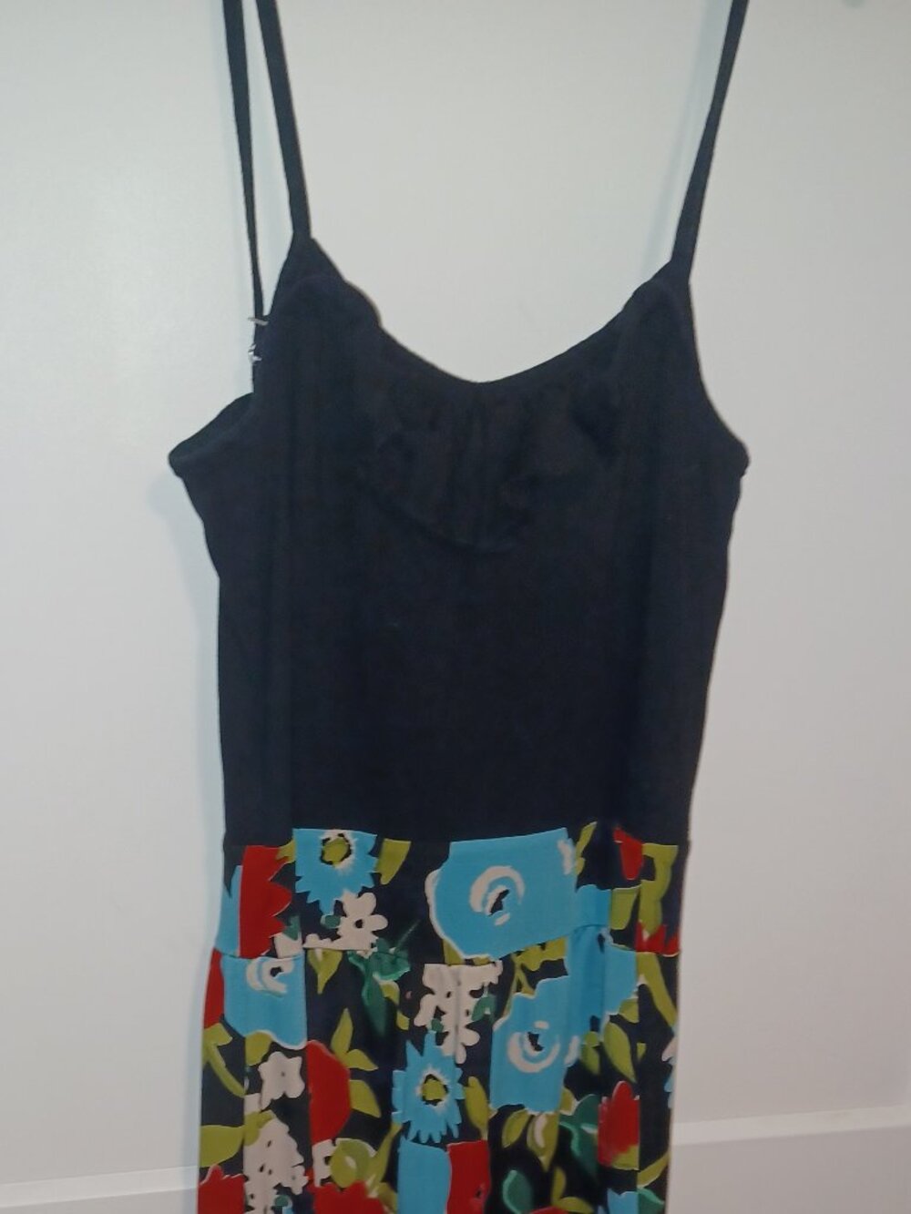 Black Planet Gold jumpsuit with vibrant teal and red trim, ruffles in the top.